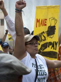 Tens of thousands descended on Wall Street for a labor demonstration against budget cuts and layoffs