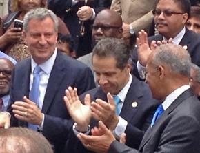 New York City Mayor Bill de Blasio (left) next to Gov. Andrew Cuomo (center) and other Democrats after he won the Democratic primary