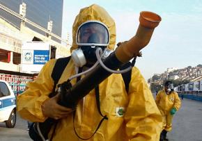 Workers in protective suits fumigate the Sambadrome ahead of the 2016 Olympics